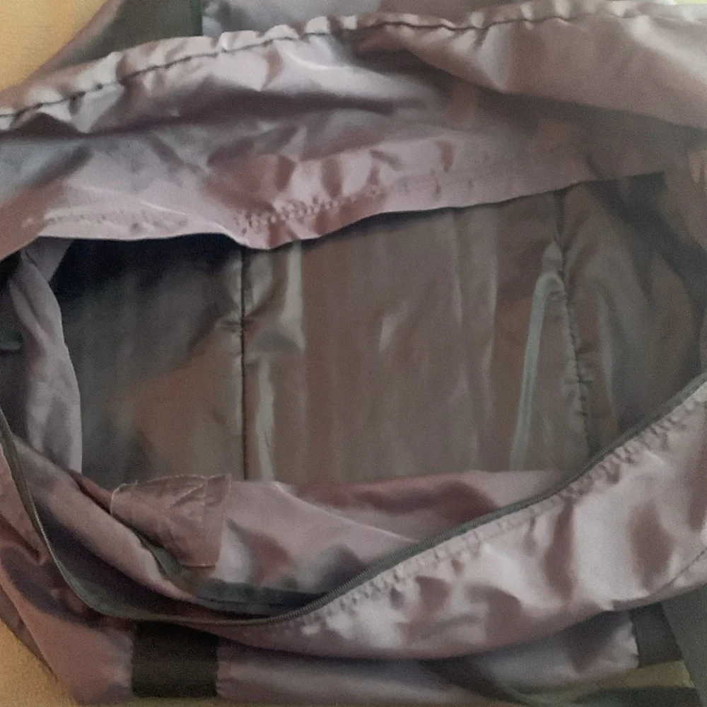 Dark gray and black nylon duffel bag. Approximately 27” x 15” x 11 1/2”